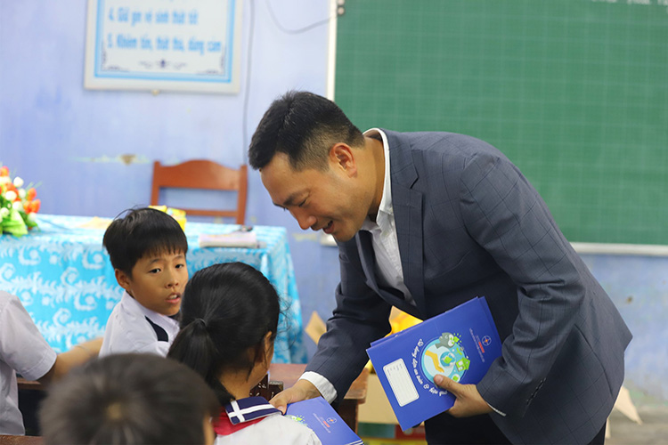 Ông Lê Ánh Dương – Phó Tổng Giám đốc EVNHANOI trao vở cho các em học sinh trường trung học Phú Thanh , thôn Quy Lai, xã Phú Thanh.