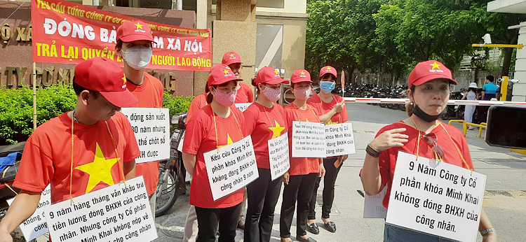 Công nhân căng biểu ngữ trước cổng tòa nhà COMA, yêu cầu Cty khoa Minh Khai khắc phục hậu quả, nộp tiền BHXH cho cán bộ công nhân viên.