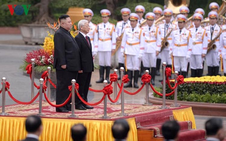 Tổng Bí thư, Chủ tịch nước Nguyễn Phú Trọng và Chủ tịch Triều Tiên Kim Jong Un trên bục danh dự, quân nhạc cử Quốc thiều hai nước (Ảnh: Vũ Toàn)
