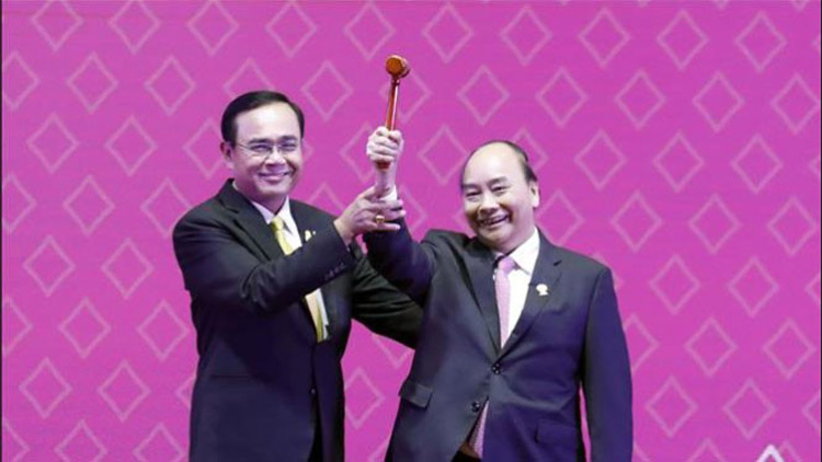 Thủ tướng Nguyễn Xuân Phúc nhận chiếc búa Chủ tịch ASEAN từ Thủ tướng Thái Lan (Ảnh: TTXVN).