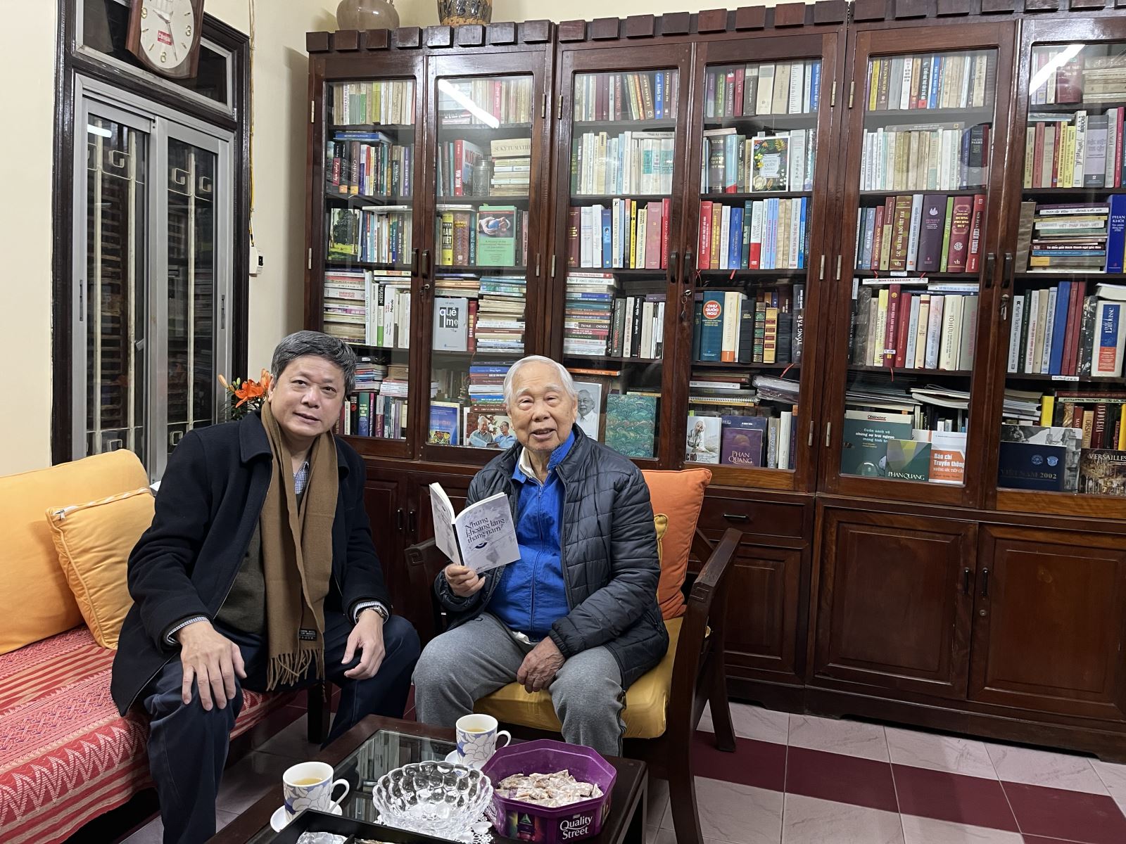 Nhà báo Vũ Hải (bên trái) tặng sách nhà báo Phan Quang.