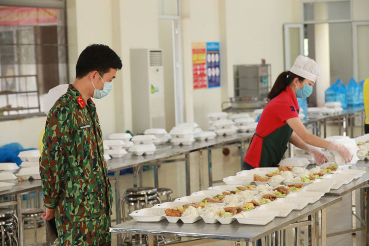 Chuẩn bị suất ăn cho người dân cách ly tại trường quân sự Bộ Tư lệnh thủ đô (Ảnh: Quang Vinh)
