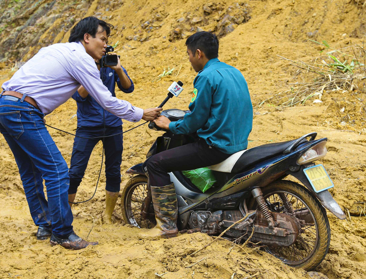 Phóng viên CQTT TTXVN tại Điện Biên đưa tin về ảnh hưởng của mưa lũ trên địa bàn huyện Nậm Pồ, Điện Biên.