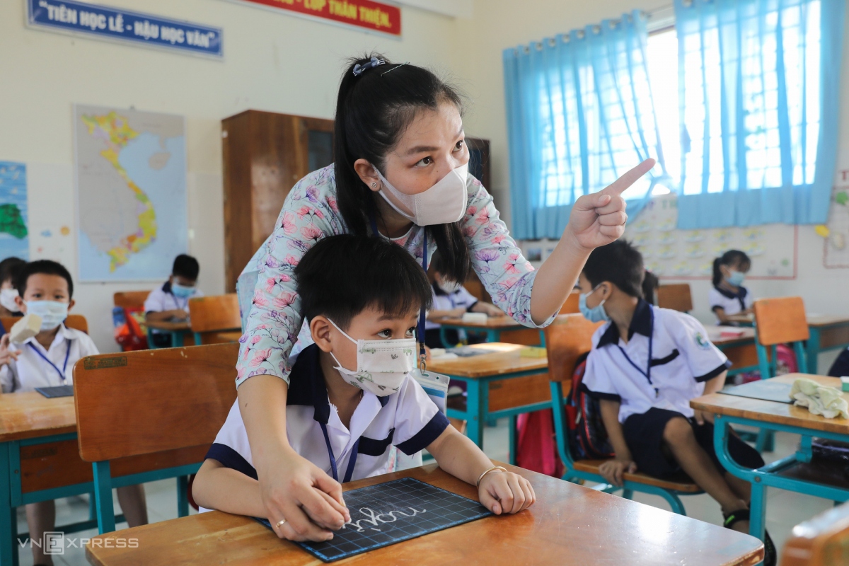 Giáo viên trường Tiểu học Thạnh An, huyện Cần Giờ dạy học sinh tập viết trong buổi học hồi tháng 10/2021. Ảnh: Quỳnh Trần/VnExpress